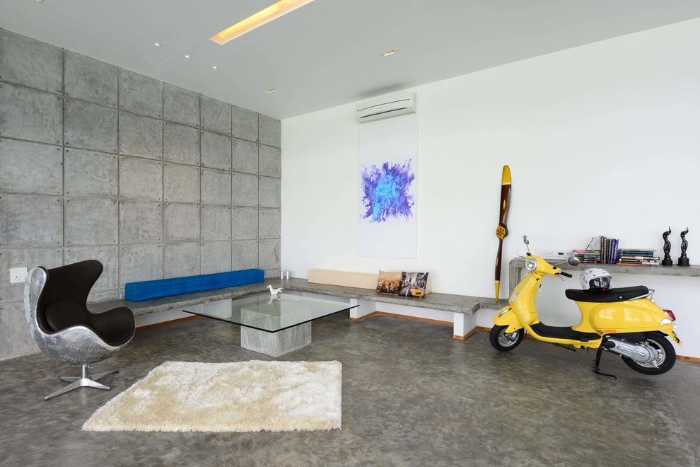 Diseño de sala de estar contemporánea de tamaño medio con paredes blancas y suelo de cemento