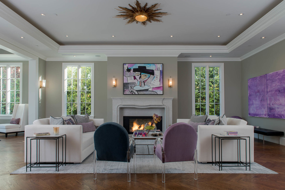 Example of a transitional formal medium tone wood floor living room design in Los Angeles with gray walls, a standard fireplace and no tv
