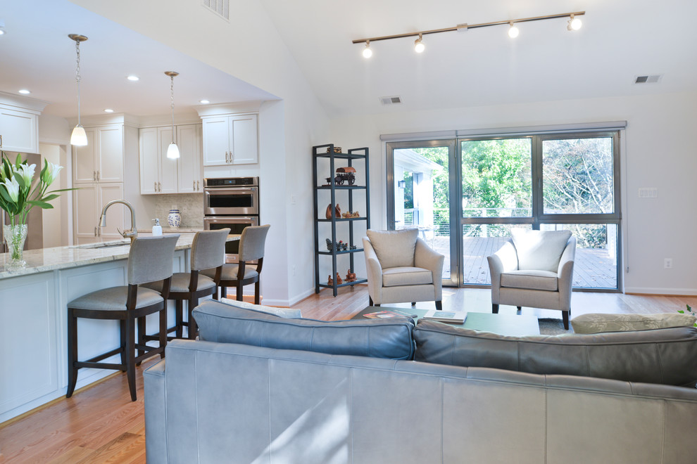 Photo of an expansive modern formal open plan living room in DC Metro with white walls, light hardwood flooring, no fireplace and brown floors.