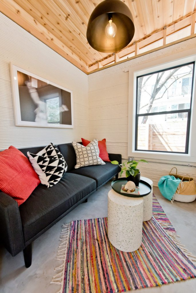 This is an example of a medium sized industrial living room in Austin with white walls and no fireplace.