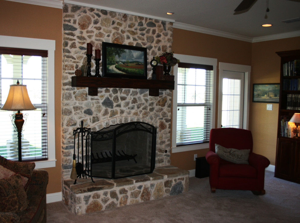 This is an example of a medium sized rural open plan living room in Dallas with beige walls, carpet, a standard fireplace and a brick fireplace surround.