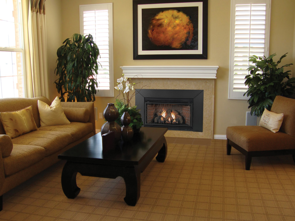 Example of a mid-sized classic formal and enclosed medium tone wood floor and brown floor living room design in Dallas with beige walls, a standard fireplace, a tile fireplace and no tv