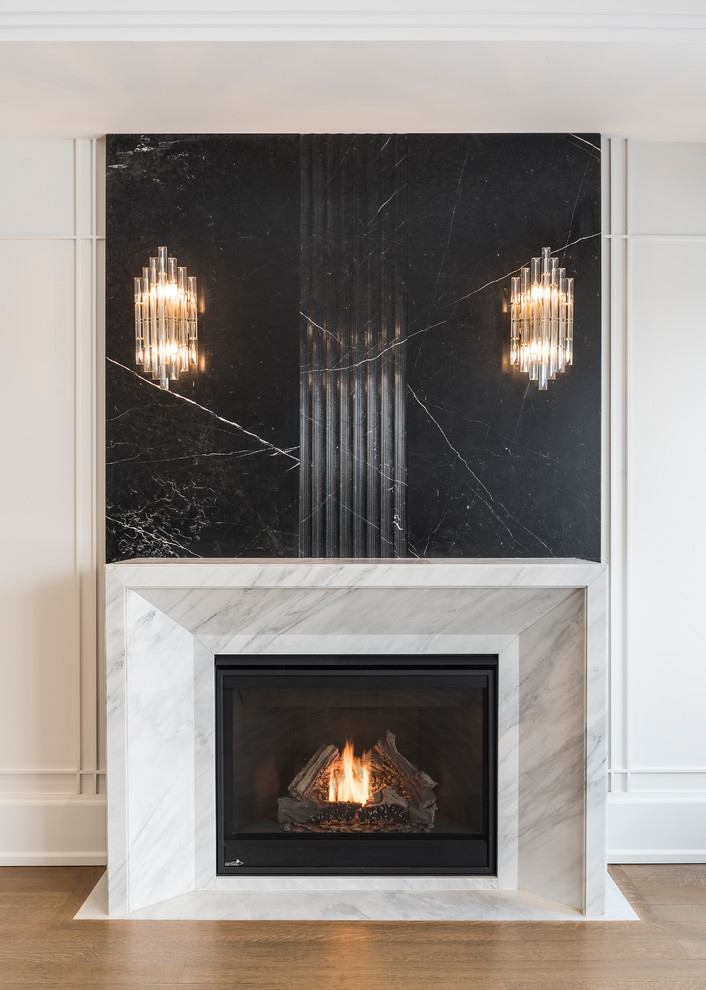 トロントにある高級な広いトランジショナルスタイルのおしゃれなリビング (白い壁、無垢フローリング、標準型暖炉、石材の暖炉まわり) の写真