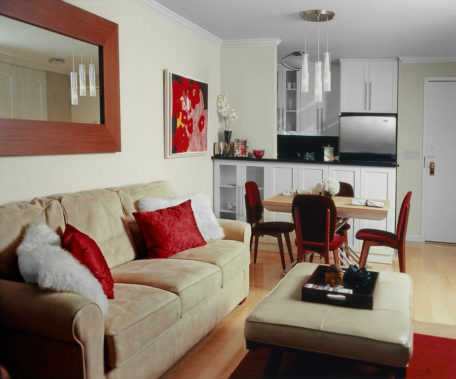 Example of a small trendy open concept light wood floor and beige floor living room design in New York with beige walls