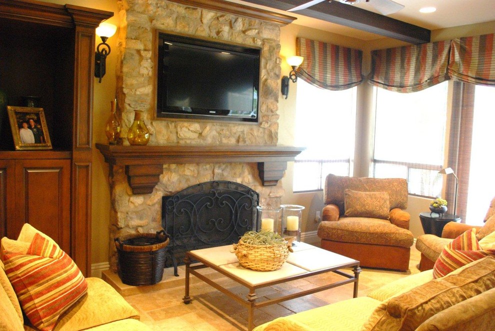 Medium sized mediterranean open plan living room in Orange County with beige walls, a stone fireplace surround and a wall mounted tv.