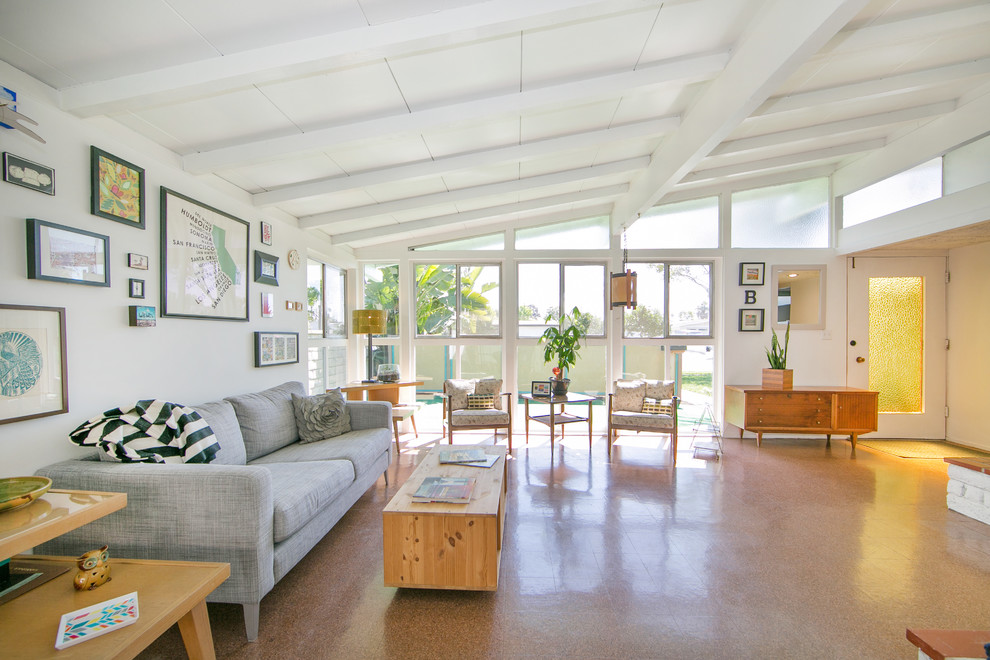 Photo of a retro open plan living room in Orange County with white walls.
