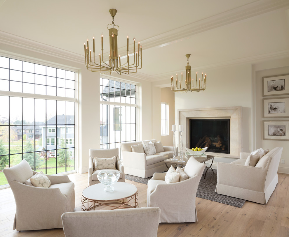 Living room - transitional open concept light wood floor and beige floor living room idea in New York with white walls and a standard fireplace