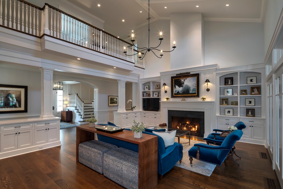 Photo of a classic living room in Baltimore with grey walls, dark hardwood flooring, a standard fireplace, a freestanding tv and brown floors.