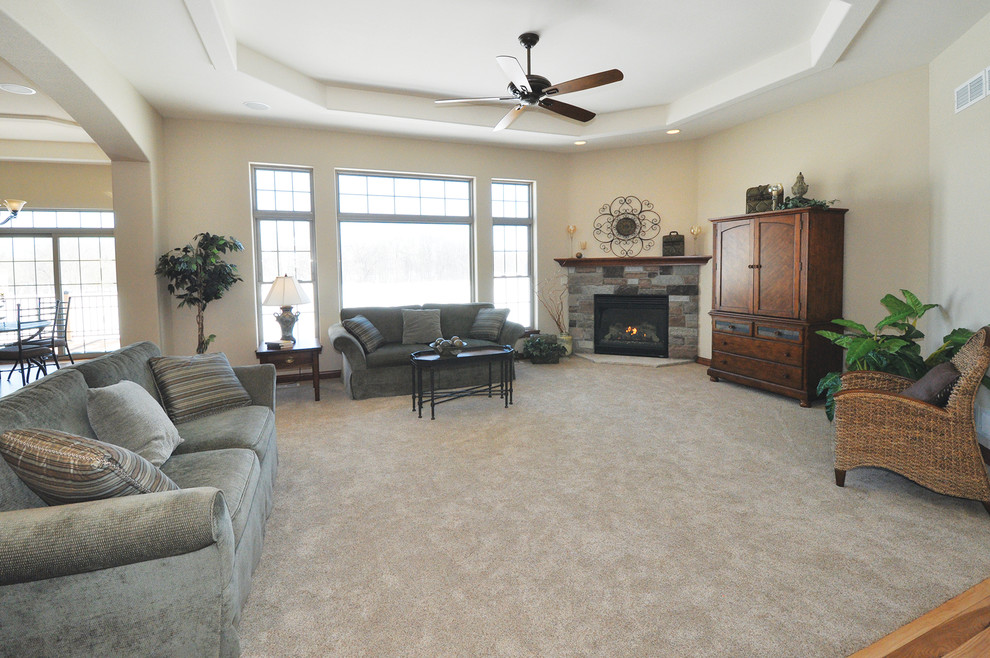 Example of a mid-sized classic open concept living room design in Milwaukee with beige walls, a corner fireplace and a stone fireplace