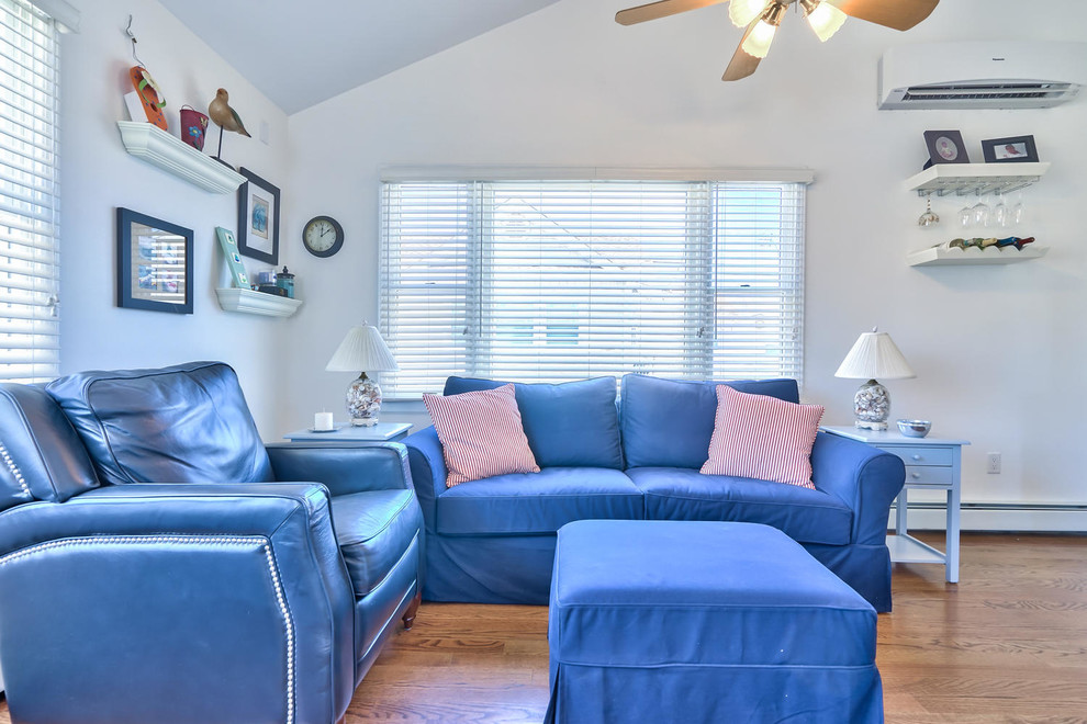 Photo of a small coastal living room in New York with medium hardwood flooring.
