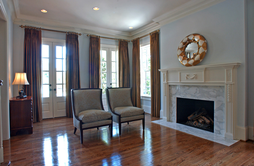 Photo of a large classic formal open plan living room in Atlanta with blue walls, medium hardwood flooring, a standard fireplace, a stone fireplace surround and no tv.