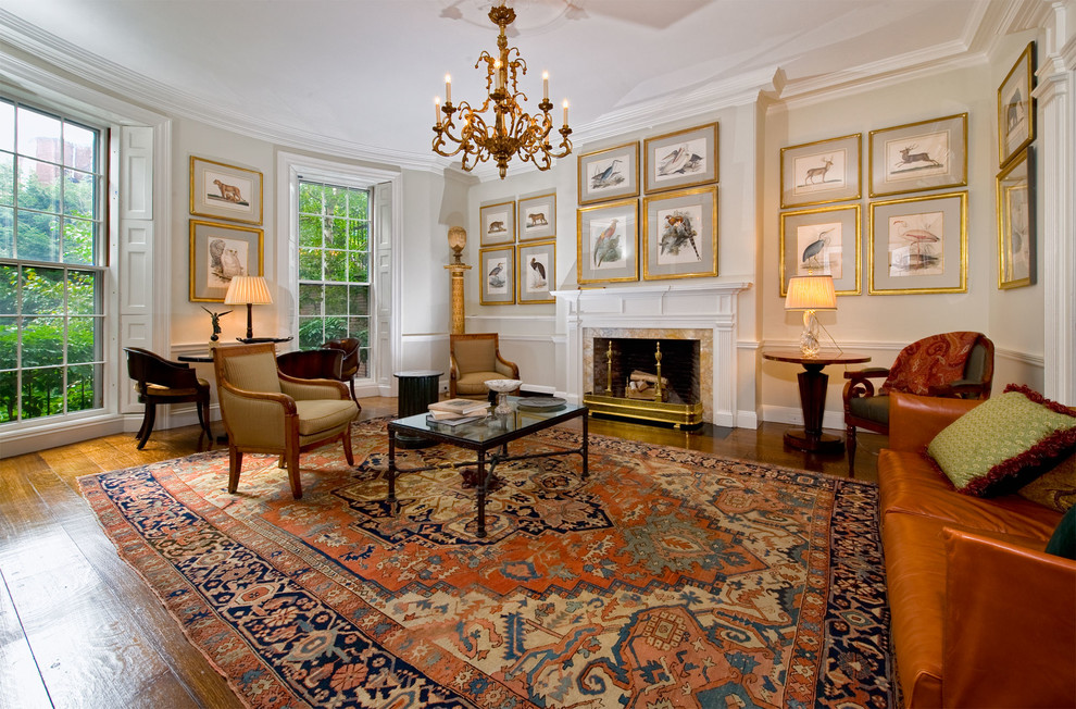 This is an example of a large classic formal enclosed living room in Boston with beige walls, dark hardwood flooring, a standard fireplace, a stone fireplace surround and no tv.