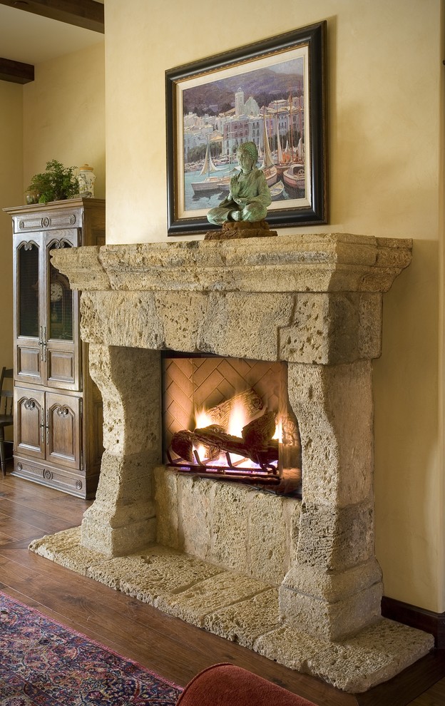 Design ideas for a mediterranean living room in Los Angeles with a stone fireplace surround.
