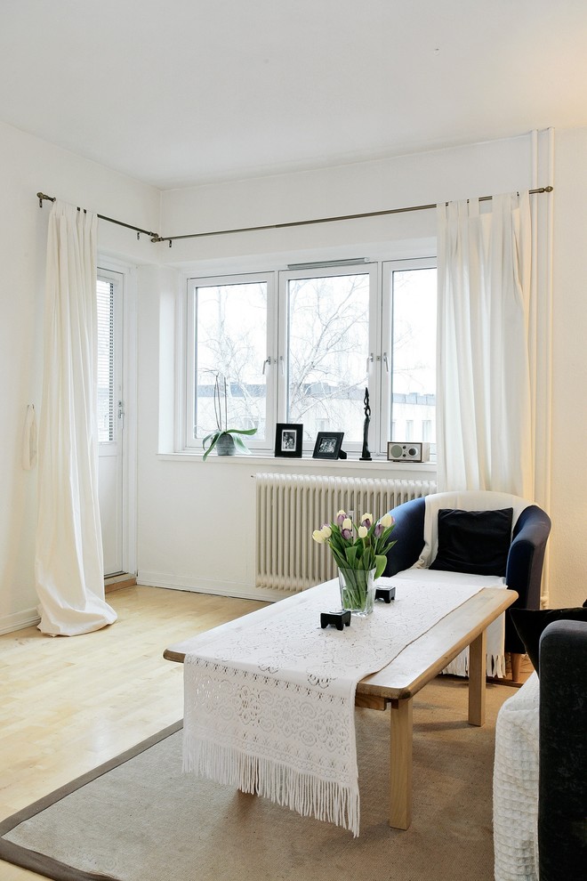 Inspiration för moderna loftrum, med vita väggar och mellanmörkt trägolv