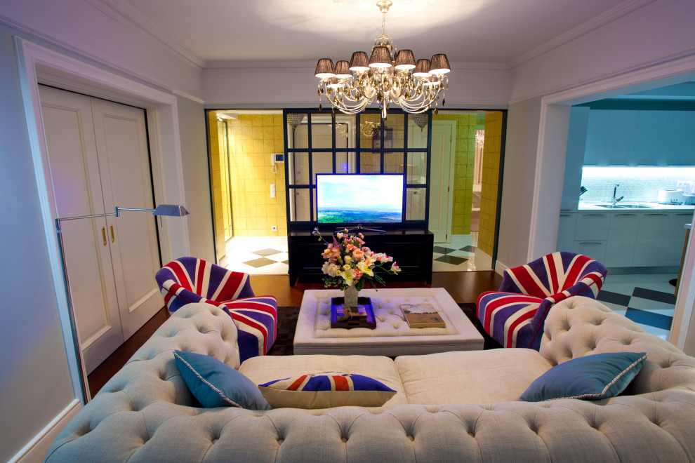 This is an example of a medium sized eclectic enclosed living room with blue walls, dark hardwood flooring, a freestanding tv, brown floors and wallpapered walls.