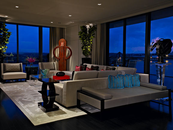 Example of a large trendy open concept dark wood floor living room design in Miami with beige walls and no fireplace