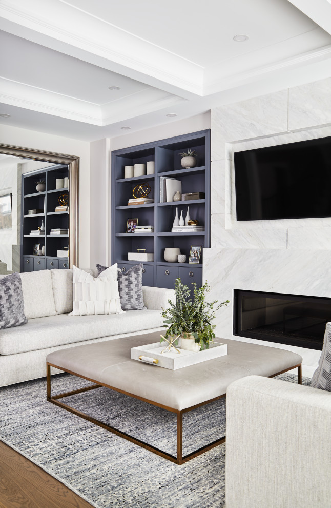 Example of a large transitional medium tone wood floor, brown floor and coffered ceiling living room design in Toronto with gray walls, a standard fireplace, a tile fireplace and a wall-mounted tv