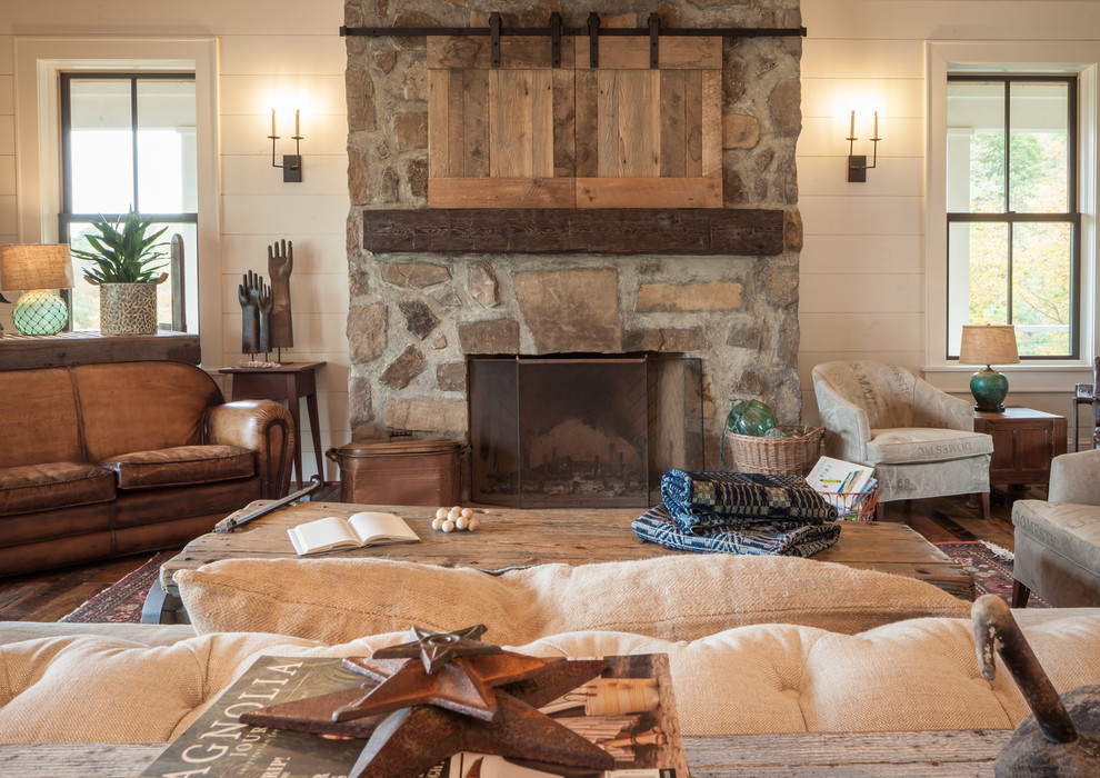 Photo of a medium sized rural formal enclosed living room in Other with white walls, a standard fireplace, a stone fireplace surround, a concealed tv, dark hardwood flooring and white floors.