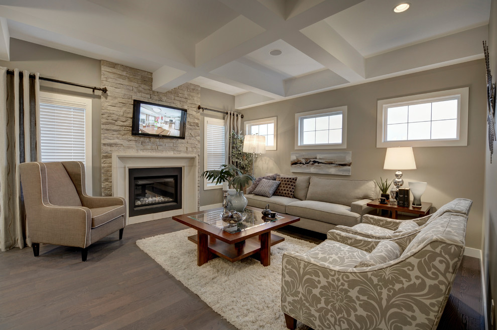 Inspiration for a mid-sized transitional open concept medium tone wood floor living room remodel in Edmonton with beige walls, a standard fireplace, a wood fireplace surround and a wall-mounted tv