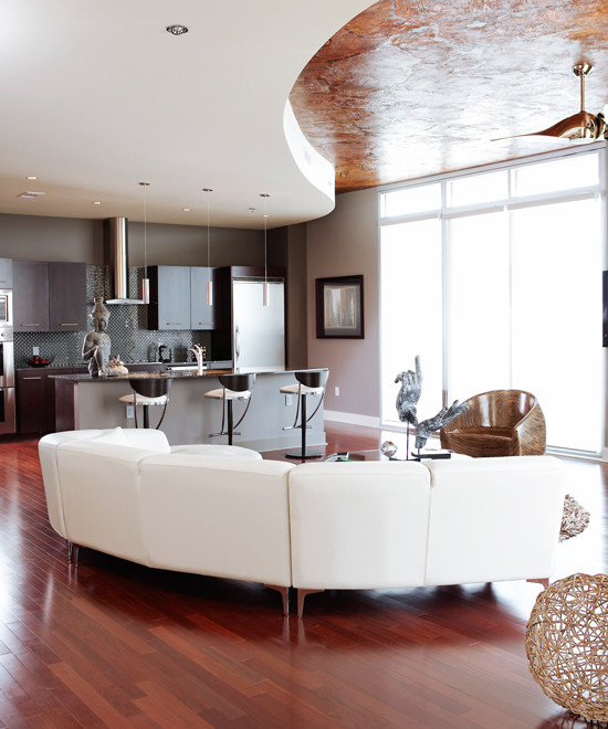 Example of a large trendy formal and open concept medium tone wood floor living room design in Atlanta with gray walls