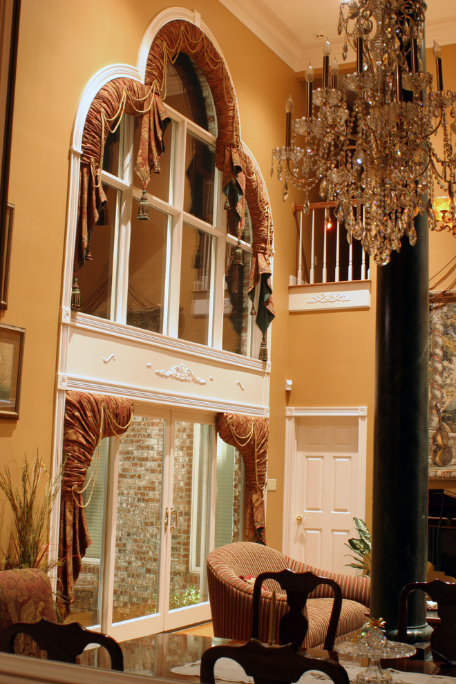 Esempio di un soggiorno chic aperto con sala formale, pareti arancioni e pavimento in legno massello medio