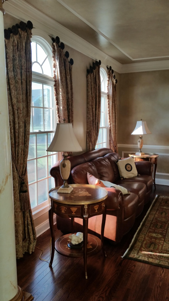 Example of a mid-sized classic formal dark wood floor, brown floor, tray ceiling and wainscoting living room design in Philadelphia with gray walls, no fireplace and no tv