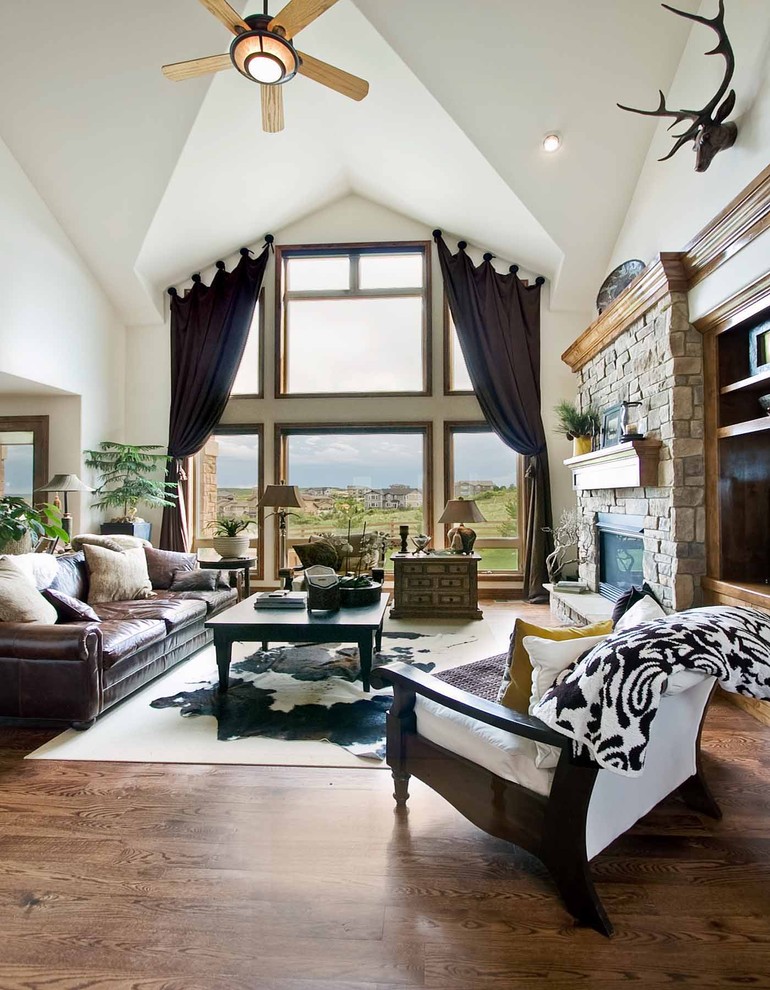 This is an example of a contemporary living room curtain in Denver with a stone fireplace surround.
