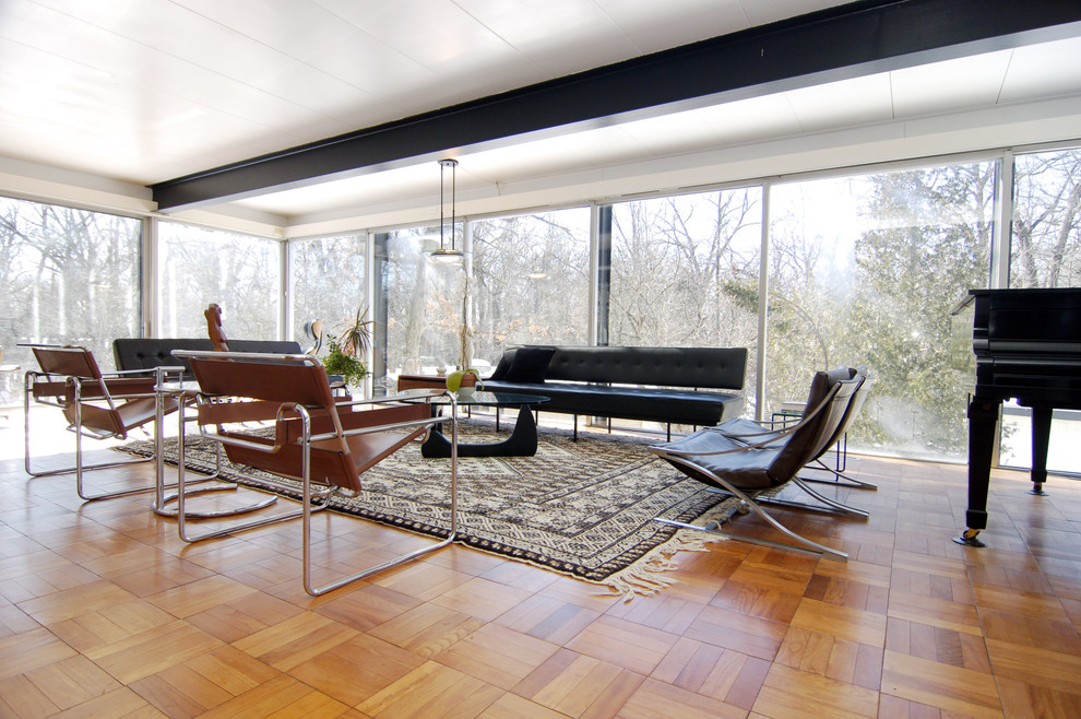 Inspiration for a modern medium tone wood floor living room remodel in Other with a music area