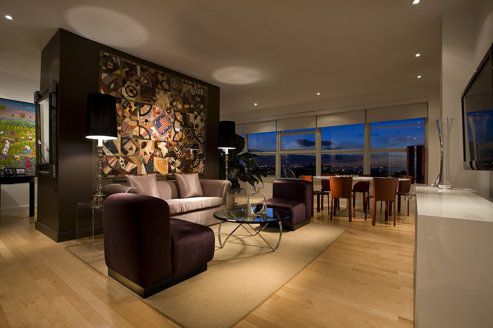 This is an example of a contemporary living room in Miami with brown walls and light hardwood flooring.