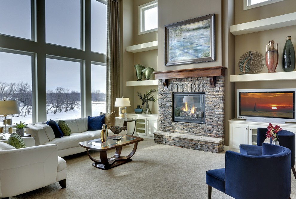 Large contemporary open plan living room in New York with beige walls, a standard fireplace, a stone fireplace surround, no tv and feature lighting.