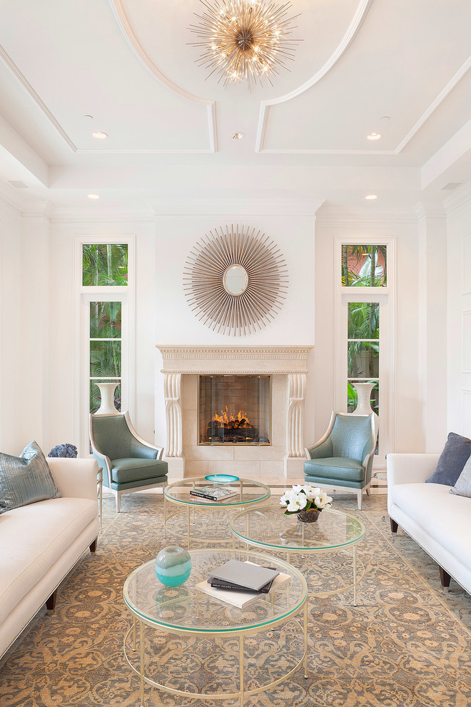 This is an example of a traditional formal living room in Miami with white walls and a standard fireplace.