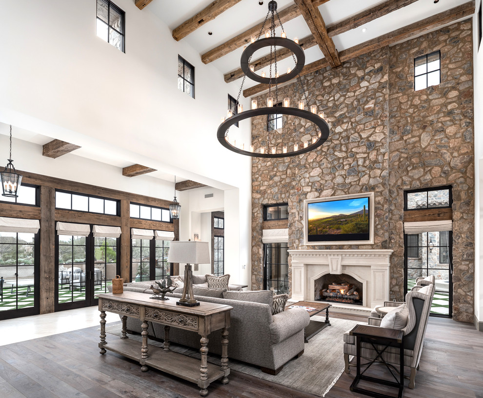 Living room - huge modern formal and open concept dark wood floor and brown floor living room idea in Phoenix with multicolored walls, a standard fireplace, a stone fireplace and a wall-mounted tv