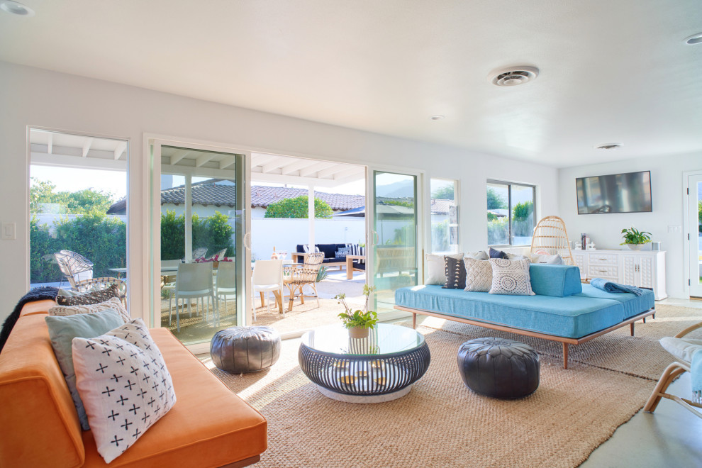 Example of a beach style open concept gray floor living room design in Los Angeles with white walls