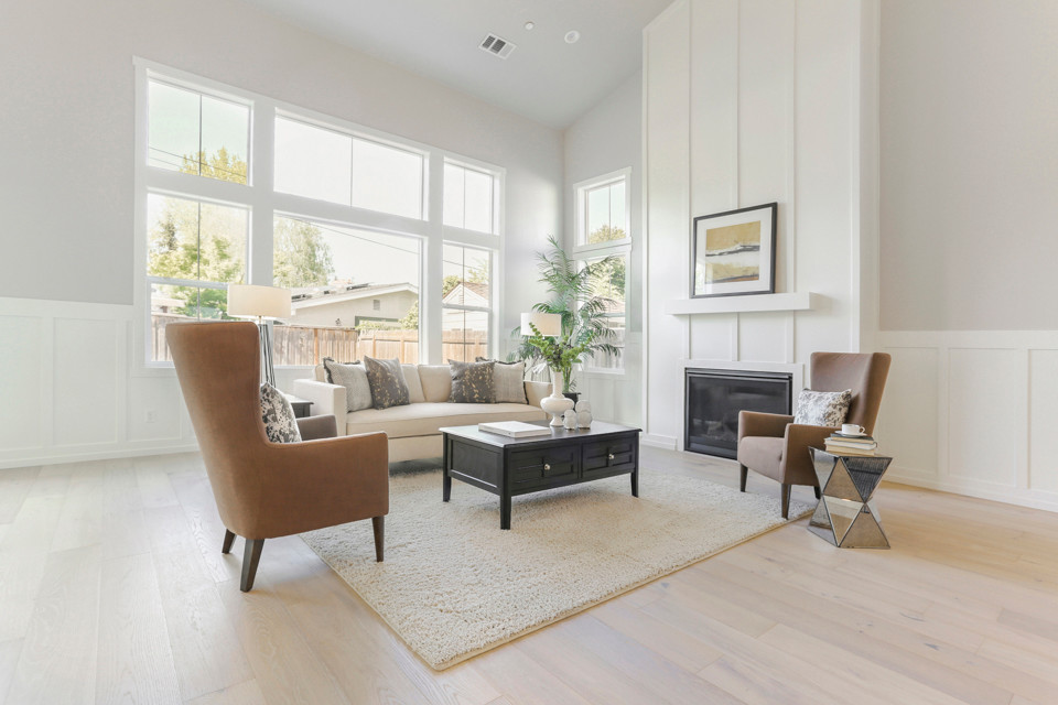 Photo of a medium sized country formal open plan living room in Sacramento with grey walls, light hardwood flooring, a standard fireplace, a wooden fireplace surround and white floors.