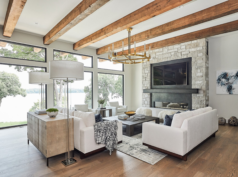 Example of a trendy open concept dark wood floor and brown floor living room design in Minneapolis with a stone fireplace, gray walls, a ribbon fireplace and a wall-mounted tv