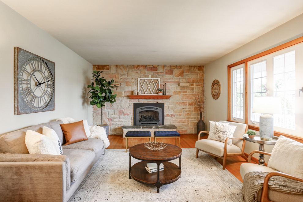 Photo of a rural formal enclosed living room in Other with white walls, medium hardwood flooring, a standard fireplace and brown floors.