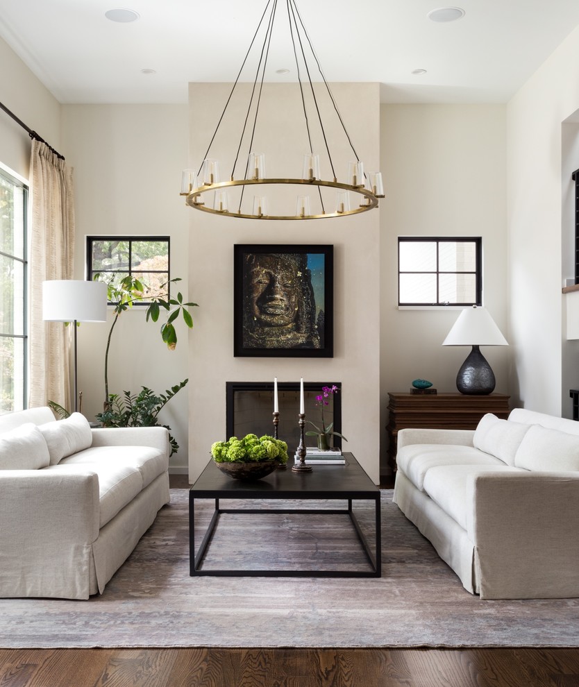 Inspiration for a traditional living room in DC Metro with beige walls, dark hardwood flooring, a standard fireplace and brown floors.