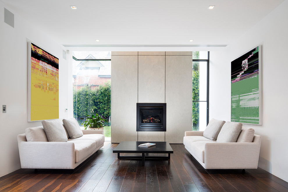 Inspiration for a medium sized contemporary formal open plan living room in Melbourne with dark hardwood flooring, a standard fireplace and white walls.