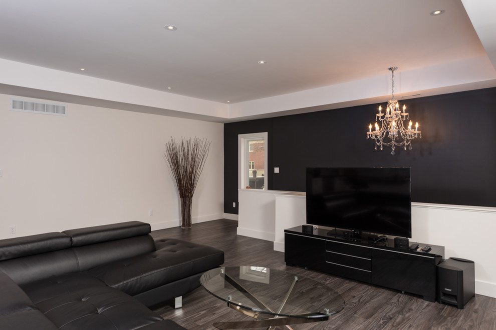 Medium sized modern open plan living room with multi-coloured walls, medium hardwood flooring and a freestanding tv.