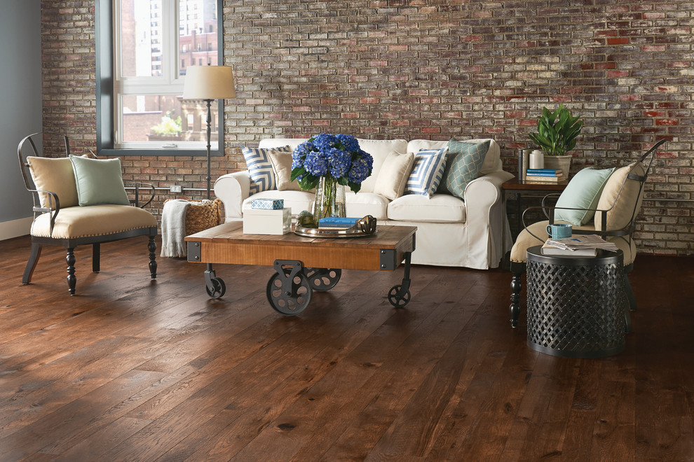 Inspiration for a large industrial formal open plan living room in Cincinnati with brown walls, dark hardwood flooring, no tv and brown floors.