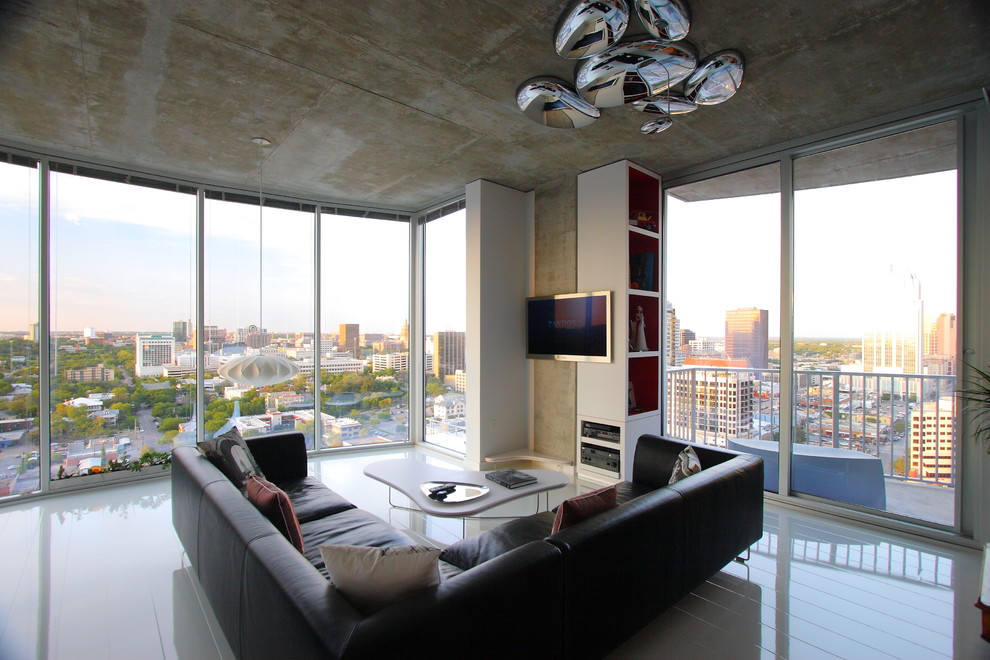 Large minimalist enclosed porcelain tile living room photo in Austin with a wall-mounted tv, black walls and no fireplace