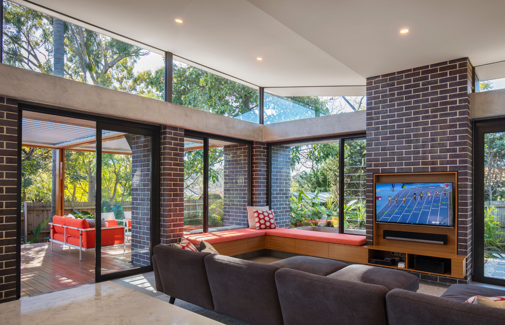 Photo of a medium sized contemporary open plan living room in Sydney with concrete flooring, no fireplace, a built-in media unit, grey floors and beige walls.