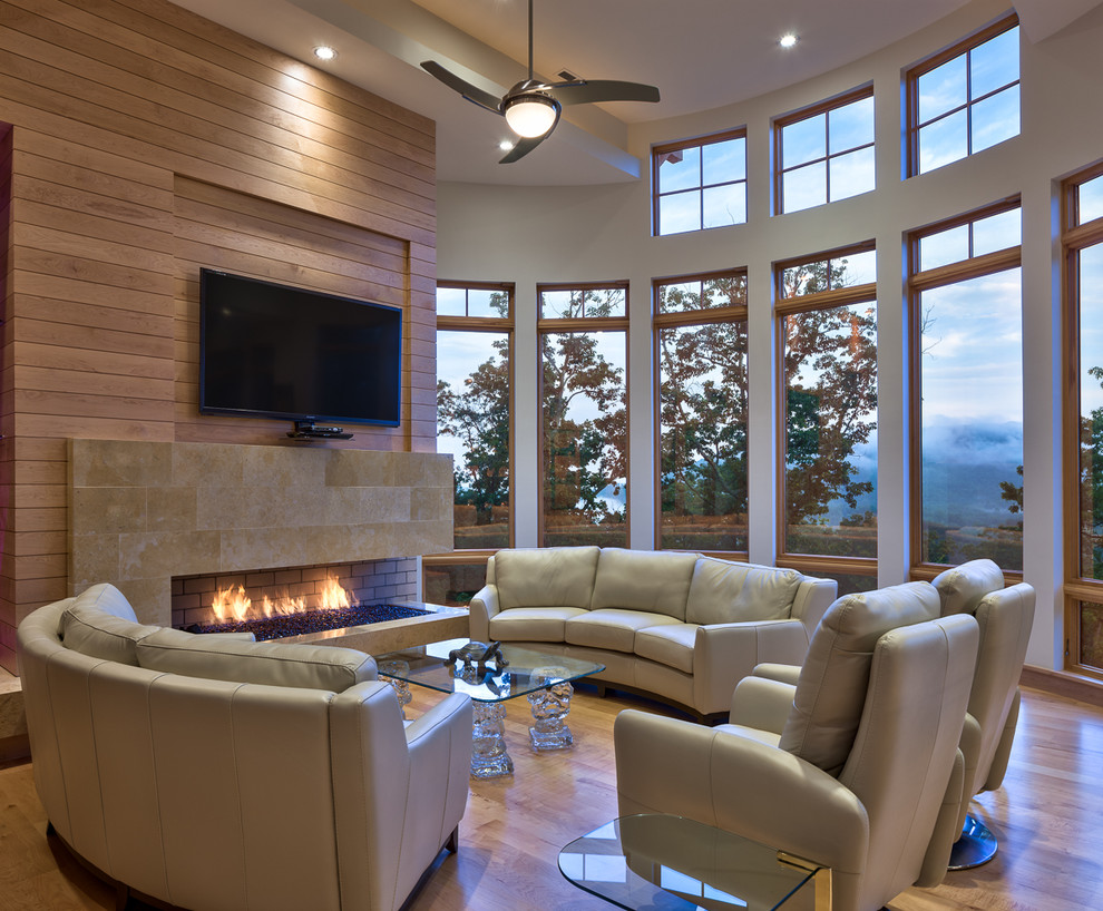 Photo of a contemporary living room in Other with a ribbon fireplace and a wall mounted tv.
