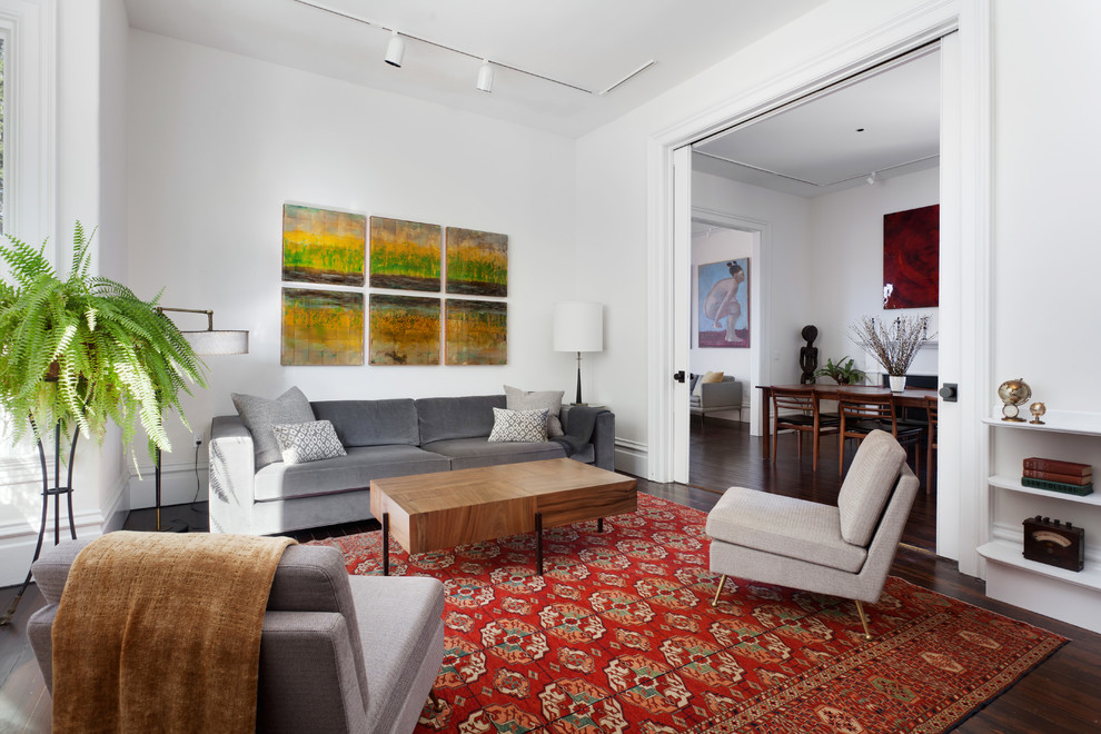 Medium sized contemporary formal enclosed living room in San Francisco with white walls, dark hardwood flooring, no fireplace, no tv and brown floors.