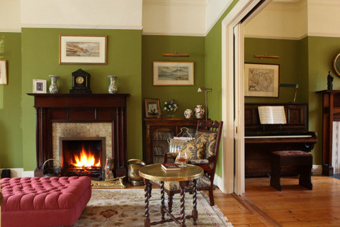 Стильный дизайн: парадная гостиная комната среднего размера в классическом стиле с зелеными стенами, паркетным полом среднего тона, стандартным камином и фасадом камина из дерева - последний тренд