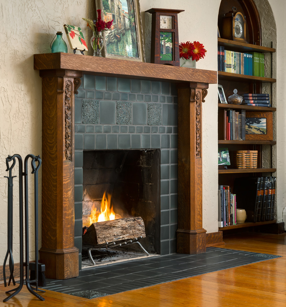 This is an example of a traditional living room in Detroit with a standard fireplace and a tiled fireplace surround.