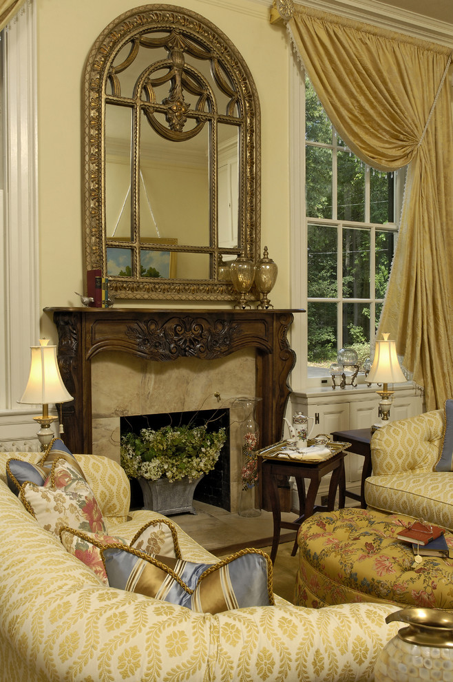 This is an example of a classic formal living room in DC Metro with beige walls, a standard fireplace and no tv.