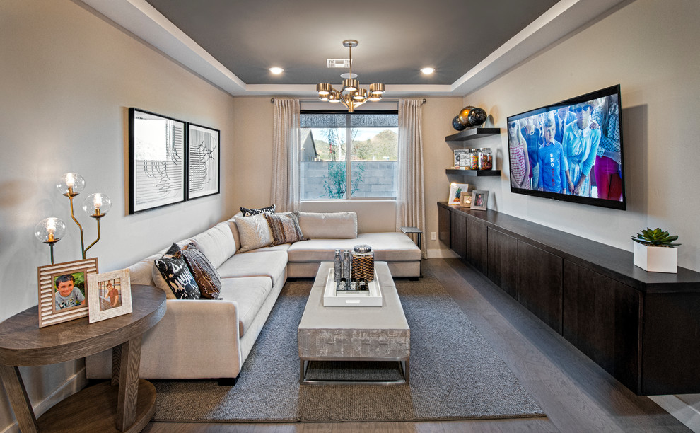 This is an example of a small contemporary enclosed living room in Phoenix with beige walls, medium hardwood flooring, a wall mounted tv and brown floors.