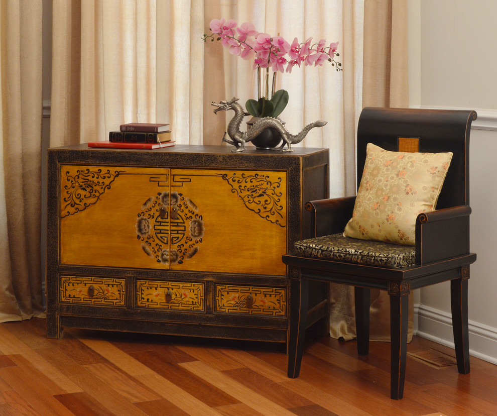Example of a small asian enclosed medium tone wood floor and brown floor living room library design in Chicago with beige walls, no fireplace and no tv