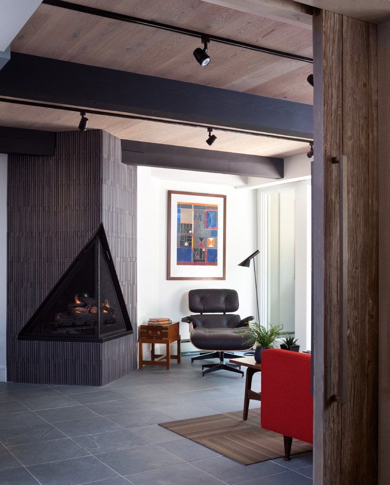 Inspiration for a mid-sized mid-century modern enclosed slate floor living room remodel in Denver with white walls, a tile fireplace and a corner fireplace